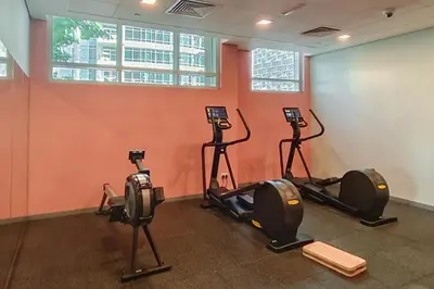 a gym with three exercise bikes in a room at Close to Metro - Classic 2BR in Loft East,Downtown in Dubai