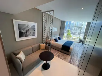 a bedroom with a couch and a bed in a room at Damac Prive l Canal View l Great Location in Dubai