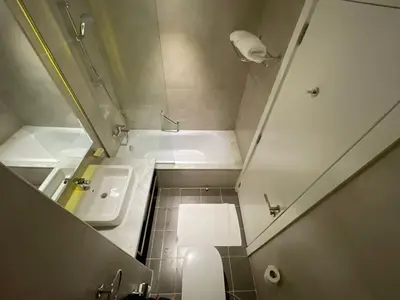 a bathroom with a tub and a toilet and a sink at Damac Prive l Canal View l Great Location in Dubai