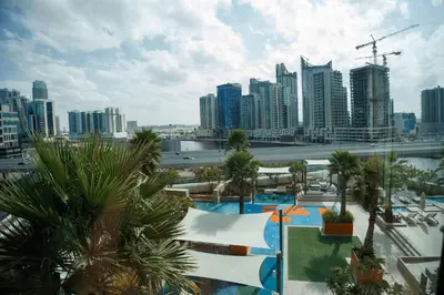 a view of a resort with a city in the background at Damac Prive l Canal View l Great Location in Dubai