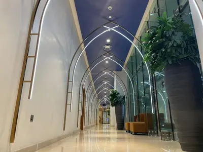 an aisle in a building with plants on the ceilings at Damac Prive l Canal View l Great Location in Dubai