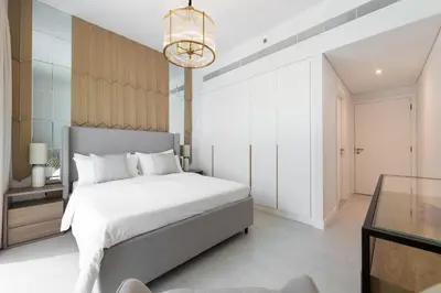 a bedroom with a bed and a chandelier at LUXSeaside/2BD/LaVie/JBR in Dubai