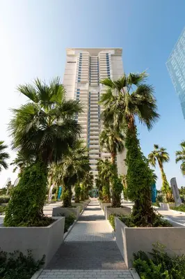 a tall building with palm trees in front of it at LUXSeaside/2BD/LaVie/JBR in Dubai