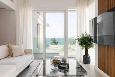 a living room with a couch and a glass table at LUXSeaside/2BD/LaVie/JBR in Dubai