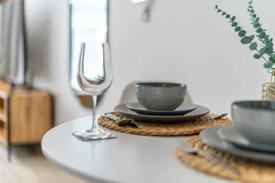 a table with a wine glass and a cup and saucer at GuestReady - A fantastic home in Business Bay in Dubai