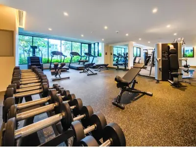 a gym with rows of exercise equipment in a room at GuestReady - A fantastic home in Business Bay in Dubai