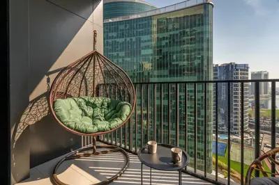 a swing on a balcony with a view of a city at GuestReady - A fantastic home in Business Bay in Dubai
