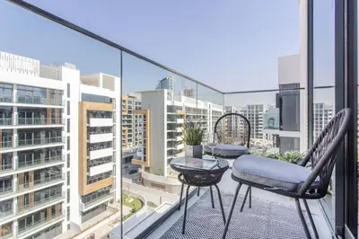 a balcony with two chairs and a table at Frank Porter - Riviera 27 in Dubai