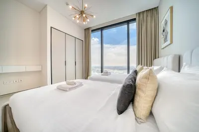 a bedroom with a large white bed with a large window at Address JBR Marina View, JBR, Dubai Marina - Mint Stay in Dubai