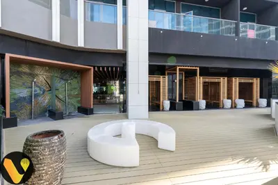 a white bench in front of a building at Vogue Business Bay, Bayz By Danube close to Downtown, Dubai Mall and Burj Khalifa, Three Bedroom Apartment with Balcony and Burj Khalifa view, Access to all Amenities in Dubai
