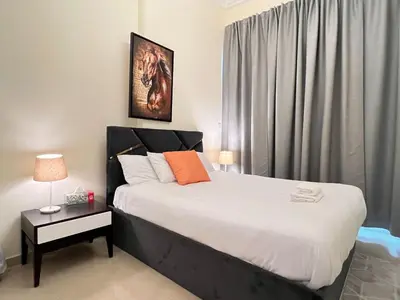 a bedroom with a large bed and a window at Dream Tower 1 in Dubai