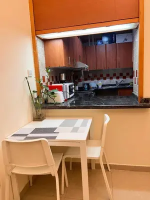 a kitchen with a table and chairs and a counter at Dream Tower 1 in Dubai
