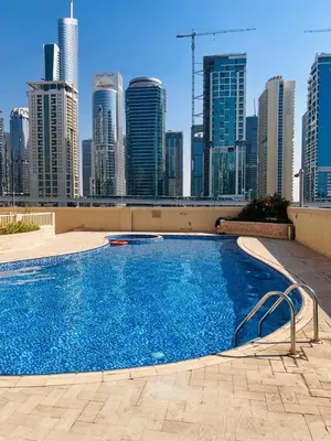 a swimming pool on top of a building with a city skyline at Dream Tower 1 in Dubai