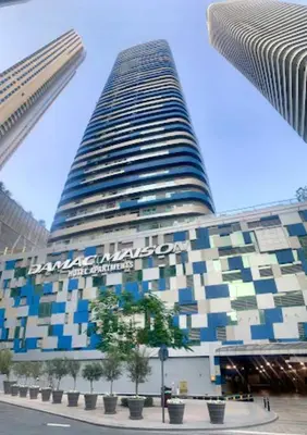 a tall building with a sign on the side of it at Elegant 1BR in Downtown, Close to Dubai Mall in Dubai