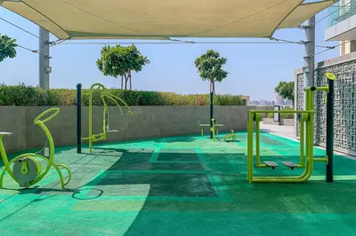 an empty playground with green in a building at Frank Porter - The Grand in Dubai