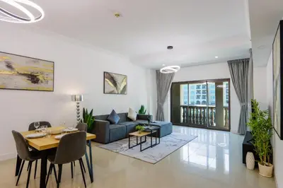 a living room with a couch and a table at 1BR in Palm Jumeirah, Walk to the Beach and Mall in Dubai