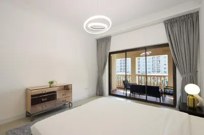 a bedroom with a large bed and a large window at 1BR in Palm Jumeirah, Walk to the Beach and Mall in Dubai