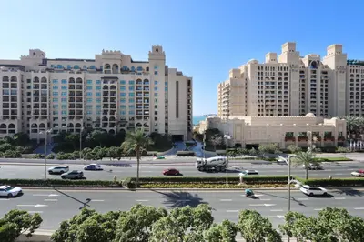 a parking lot in a city with tall buildings at 1BR in Palm Jumeirah, Walk to the Beach and Mall in Dubai