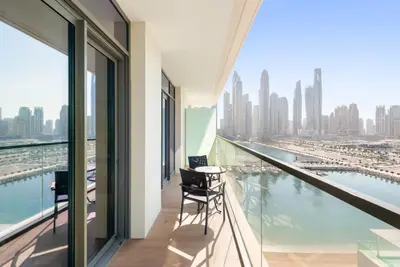 a balcony with a table and chairs and a view of the city at Silkhaus Marina View with Tower's Private Beach in Dubai
