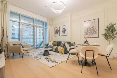 a living room with a couch and a table and chairs at Chic 1 Bed in Marina Newly Furnished,Modern Luxury in Dubai