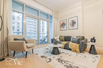 a living room with a couch and a chair at Chic 1 Bed in Marina Newly Furnished,Modern Luxury in Dubai
