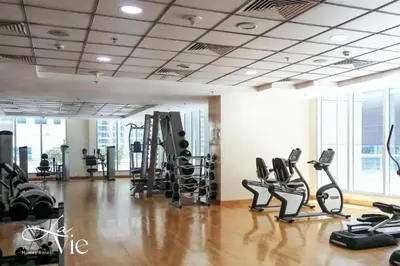 a gym with treadmills and elliptical machines at Chic 1 Bed in Marina Newly Furnished,Modern Luxury in Dubai