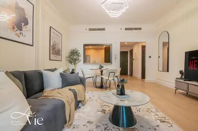 a living room with a couch and a table at Chic 1 Bed in Marina Newly Furnished,Modern Luxury in Dubai