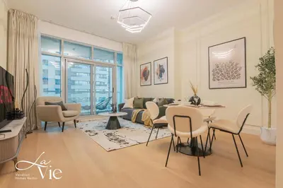 a living room with a table and chairs at Chic 1 Bed in Marina Newly Furnished,Modern Luxury in Dubai