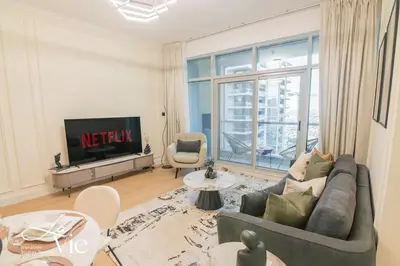 a living room with a couch and a television at Chic 1 Bed in Marina Newly Furnished,Modern Luxury in Dubai