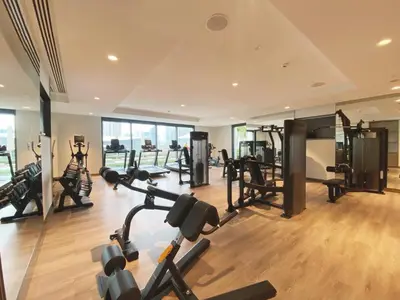 a gym with several treadmills and machines in a room at Luxury 2 Bedroom Apartment - Next to Dubai Opera in Dubai