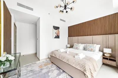 a bedroom with a large bed with a wooden headboard at Luxury 2 Bedroom Apartment - Next to Dubai Opera in Dubai