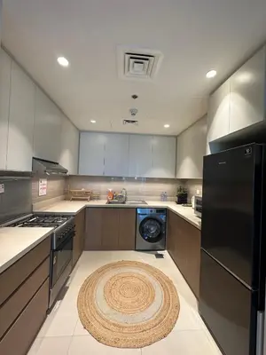 a kitchen with a washer and a rug on the floor at Beautiful Flat in Harbor Views in Dubai