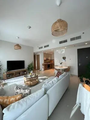 a living room with a couch and a tv at Beautiful Flat in Harbor Views in Dubai