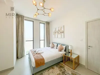 a bedroom with a bed and a large window at Mira Holiday Homes - Serviced 1 bedroom in Midtown in Dubai
