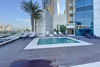 a swimming pool on the roof of a building at Botanica Tower - Bright One Bedroom in Dubai