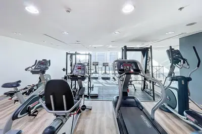 a gym with treadmills and elliptical machines at Botanica Tower - Bright One Bedroom in Dubai