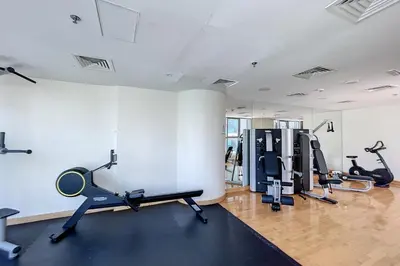 a gym with several treadmills and exercise bikes at The Point Tower - Chic One Bedroom in Dubai