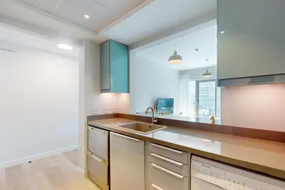 a kitchen with a sink and a large window at The Point Tower - Chic One Bedroom in Dubai
