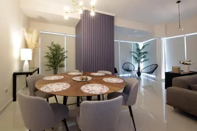 a dining room with a wooden table and chairs at AHH - Panoramic Marina Views - Stylish 2BR at DAMAC Heights in Dubai