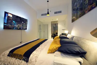 a bedroom with a large bed with pillows on it at AHH - Panoramic Marina Views - Stylish 2BR at DAMAC Heights in Dubai