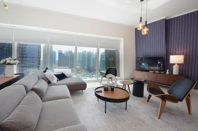 a living room with a couch and a large window at AHH - Panoramic Marina Views - Stylish 2BR at DAMAC Heights in Dubai