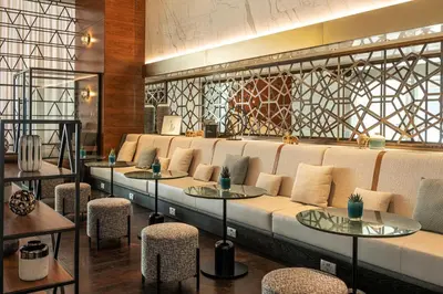 a row of tables and chairs in a restaurant at Sheraton Grand Hotel, Dubai in Dubai