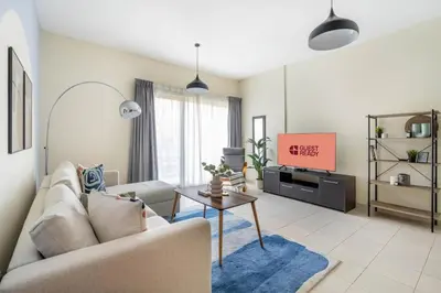 a living room with a couch and a tv at GuestReady Holiday Homes - One Mint Sunset in Dubai