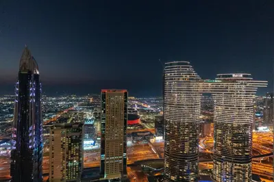 a city skyline at night with tall buildings at Vacay Lettings - Burj Vista Tower 1- Direct Dubai Mall Access in Dubai