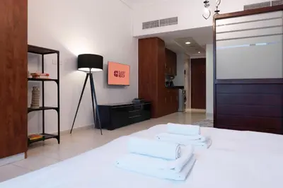 a bedroom with a bed with white towels on it at GuestReady Holiday Homes - Hibernate Hideout in Dubai