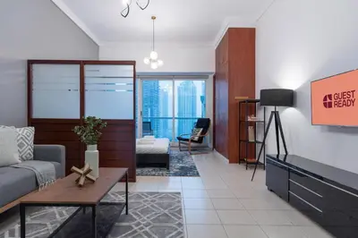 a living room with a couch and a table at GuestReady Holiday Homes - Hibernate Hideout in Dubai