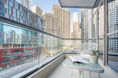 a balcony with a table and a view of a city at GuestReady - Comfort Stay l Close To Marina Mall in Dubai