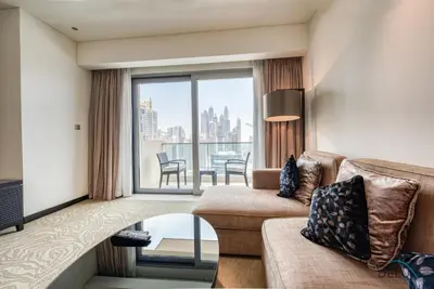 a living room with a couch and a large window at Posh 1BR at The Address Residences Dubai Marina by Deluxe Holiday Homes in Dubai