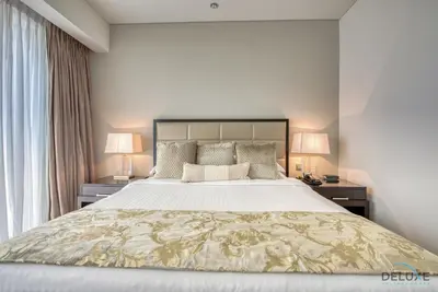 a bedroom with a large bed with two night stands at Posh 1BR at The Address Residences Dubai Marina by Deluxe Holiday Homes in Dubai