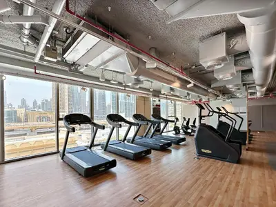 a gym with a row of treadmills at Brand New Elegant 1BDR Direct Access to Dubai Mall in Dubai